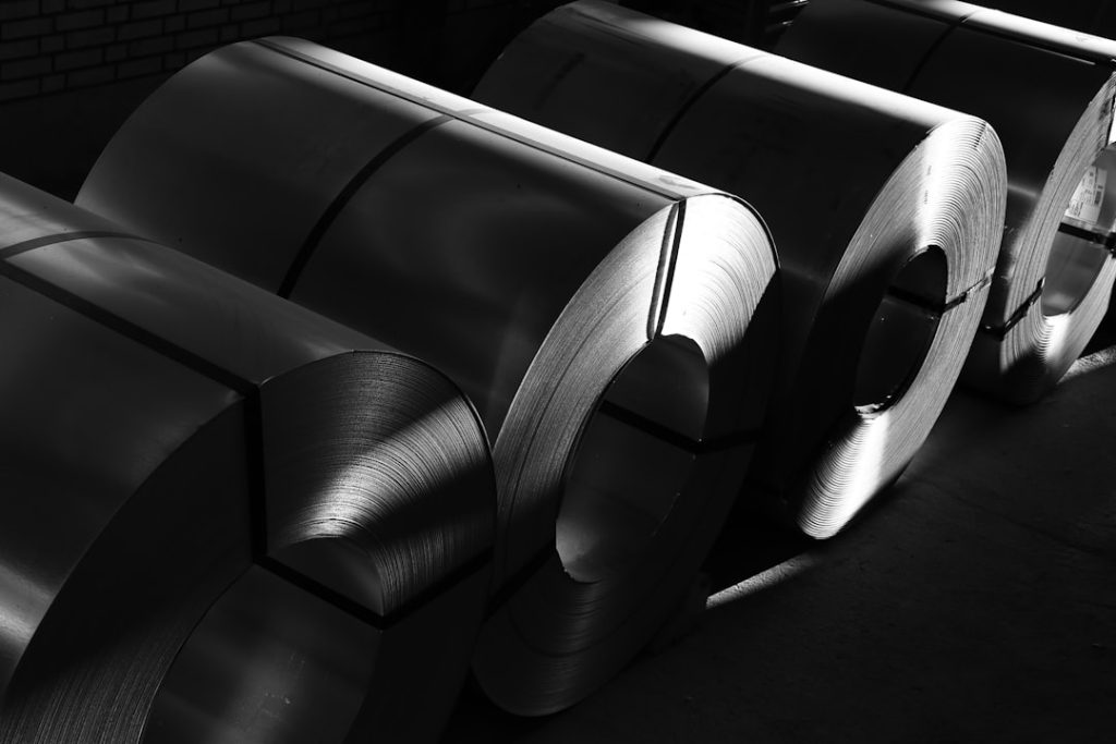 a-black-and-white-photo-of-rolls-of-steel-1zoxcscr-ui